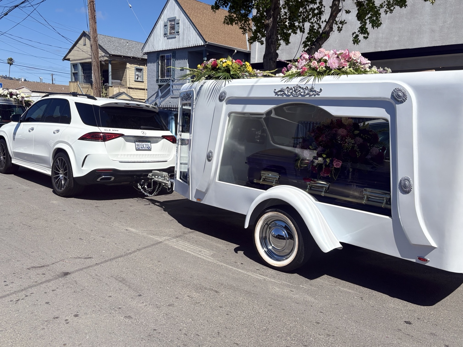 Gifted Hands white hearse trailer in procession